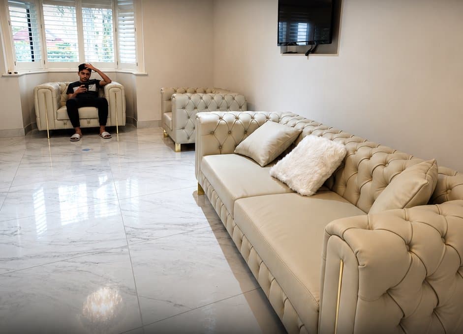 A cream tufted leather sofa set delivered to a London home