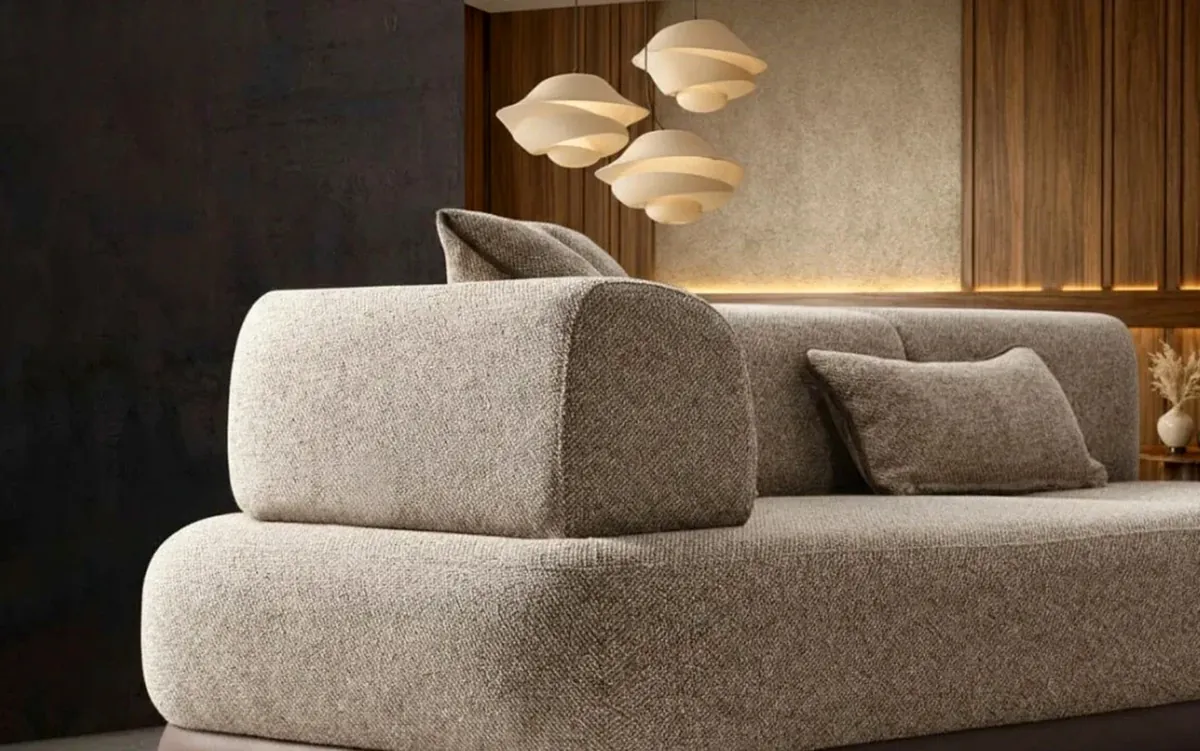 Close-up of the Mass Duru sofa's textured greige fabric and rounded arm