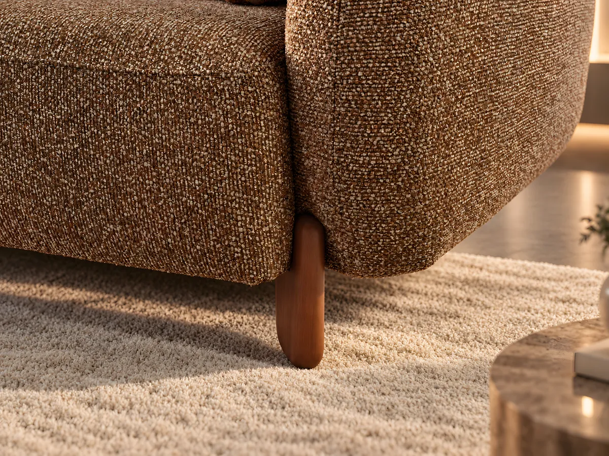 Close-up of the Vizyon sofa's rounded arm and solid wooden leg